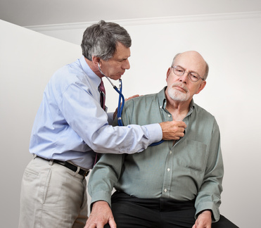 Doctor or Nurse Listens to Older Man's Heart and Lungs